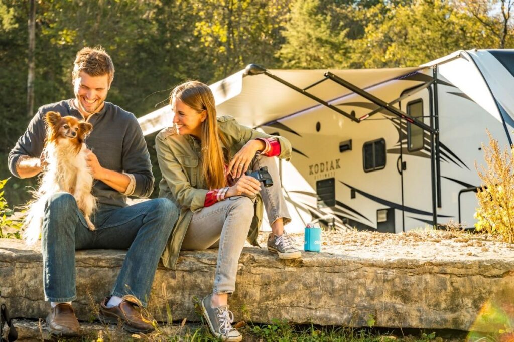 Couple sitting with dog at one of the top Unhitched RV Pet-Friendly Campgrounds in Florida